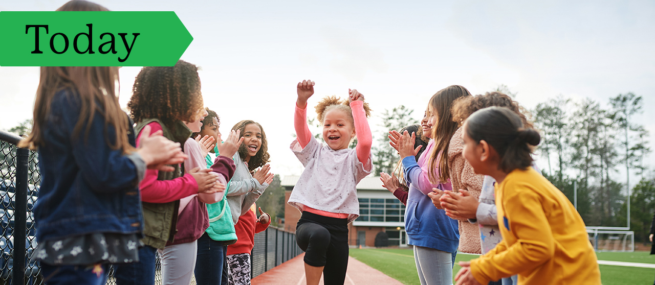 Girl Scouts participate in a track and field activity, present day.